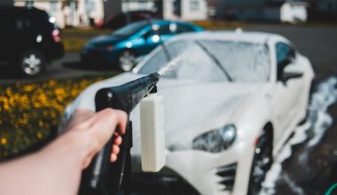Using a pressure washer to clean a car